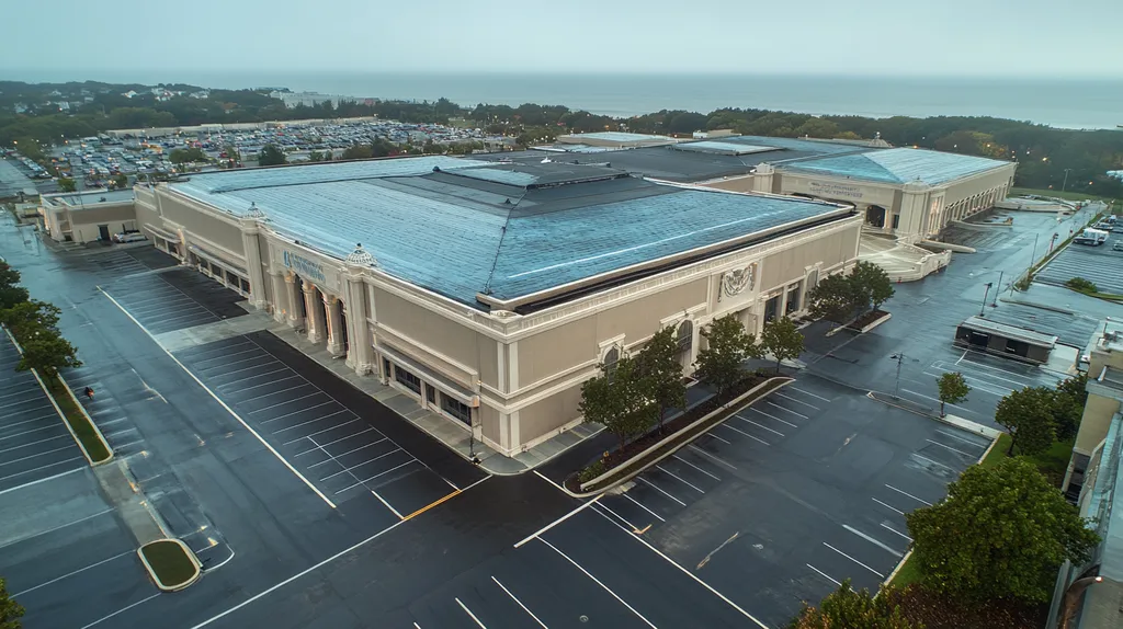 A commercial roof on a convention center in a location similar to Newport, Rhode Island with a rainy day aesthetic (AI image)