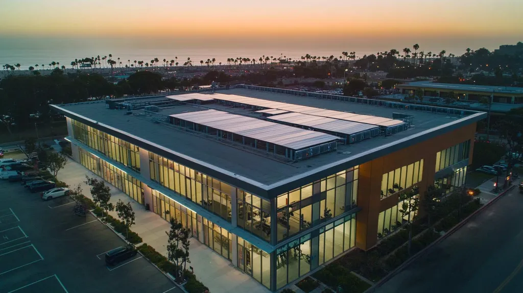 A commercial roof on a fitness gym in a location similar to Santa Monica with an illuminated nightscape aesthetic (AI image)