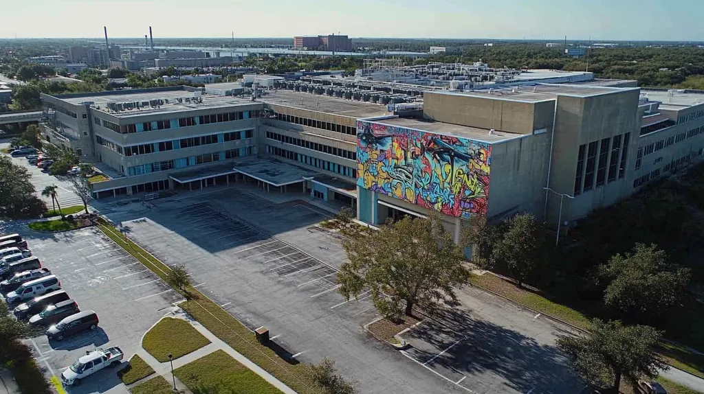 A commercial roof on a hospital in a location similar to Jacksonville with a graffiti mural aesthetic (AI image)
