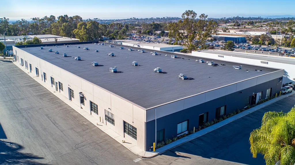A commercial roof on a warehouse in a location similar to San Diego with a color highlight aesthetic (AI image)