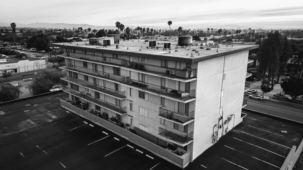A commercial roof on high-rise apartments in a location similar to Los Angeles with a charcoal sketch aesthetic (AI image)