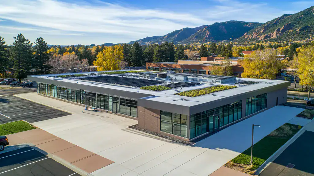 A commercial roof on a community recreation center in a location similar to Boulder with an architectural photography aesthetic (AI image)