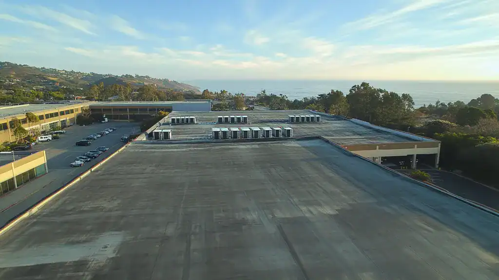 A commercial roof on a distribution center in a location similar to Big Sur with an urban context aesthetic (AI image)
