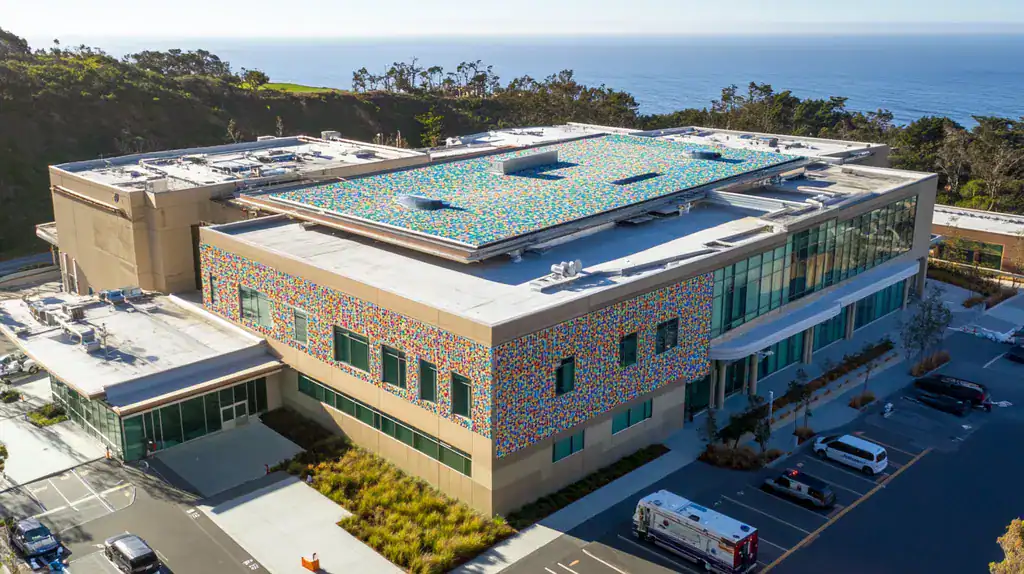 A commercial roof on a hospital in a location similar to Big Sur with a mosaic tile art aesthetic (AI image)