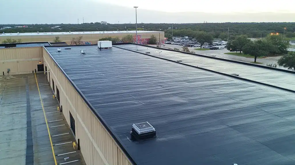 A commercial roof on a warehouse in a location similar to Austin with a rainy day aesthetic (AI image)