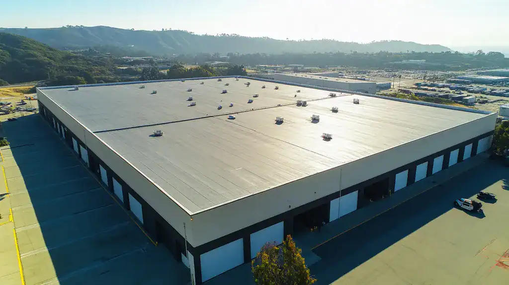 A commercial roof on a warehouse in a location similar to Big Sur with an urban context aesthetic (AI image)