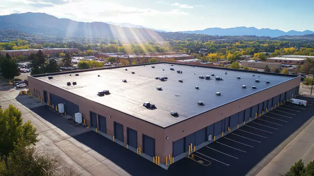A commercial roof on a warehouse in a location similar to Boulder with a light beams aesthetic (AI image)