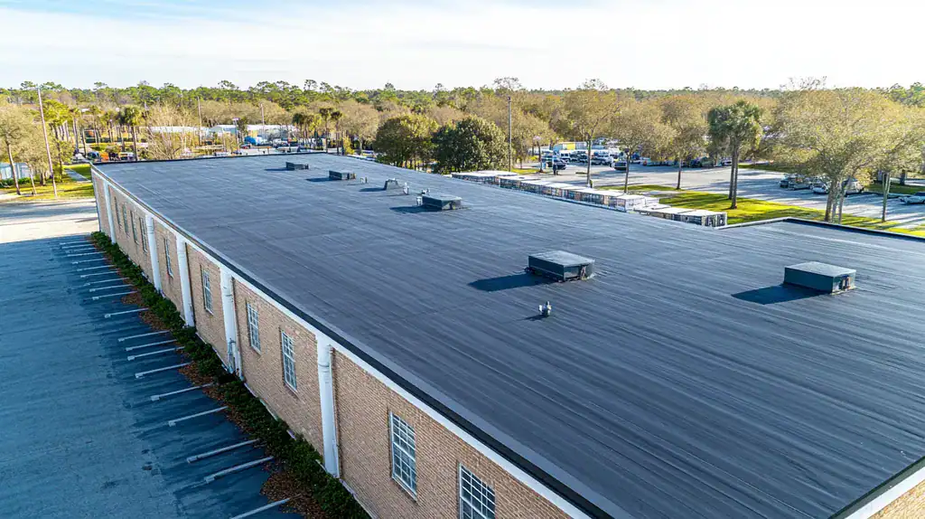 A commercial roof on a warehouse in a location similar to Charleston with a rainy day aesthetic (AI image)