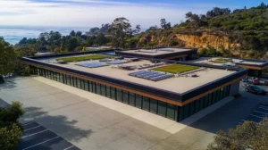 A commercial roof on a community recreation center in a location similar to Big Sur with a comic book style aesthetic (AI image)