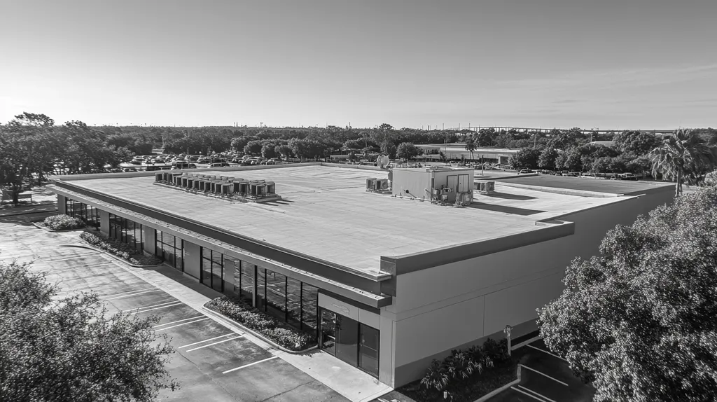 A commercial roof on a bank in a location similar to Tampa with a black and white photography aesthetic (AI image)